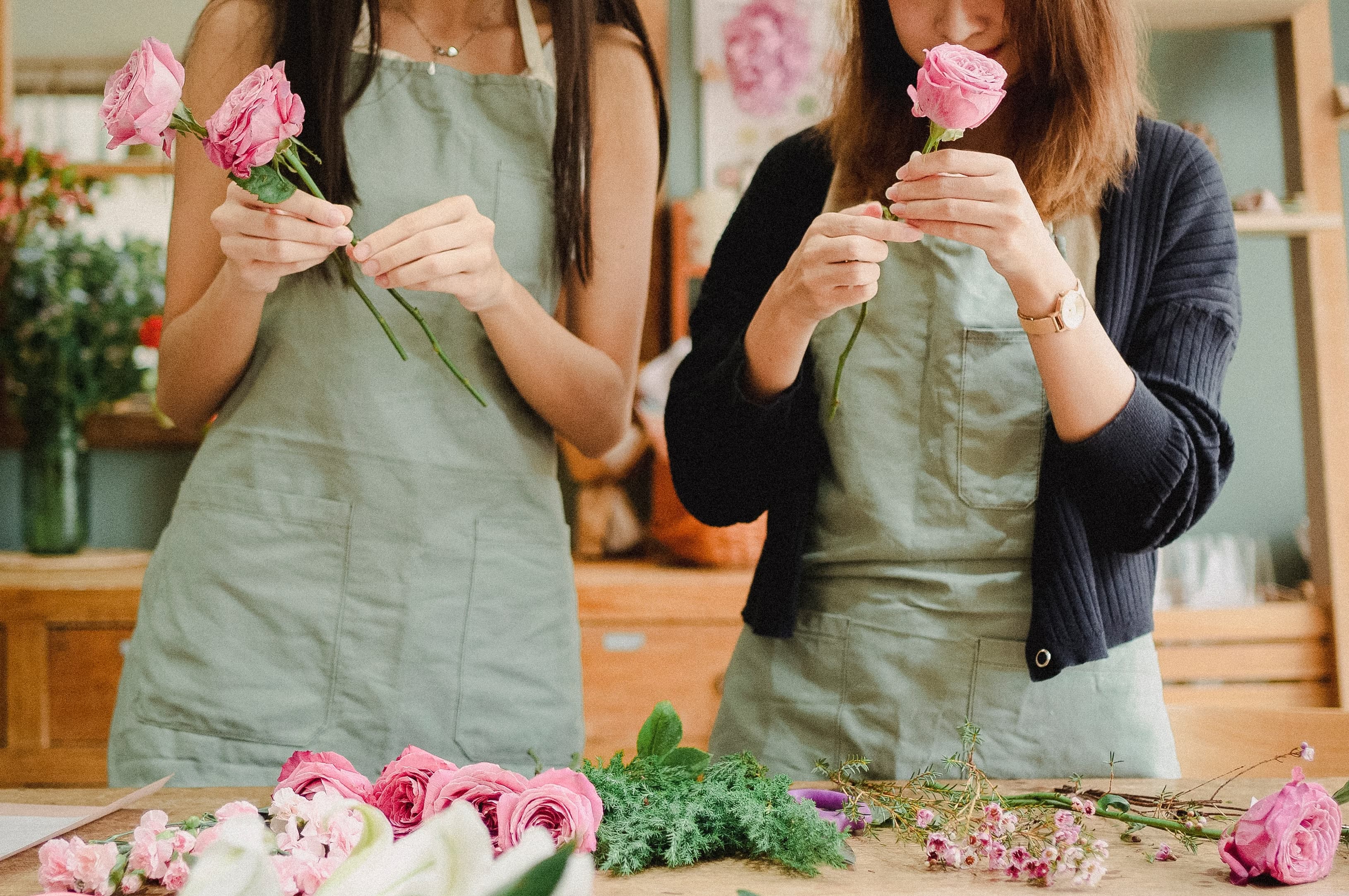 People arranging fresh flowers at a hands-on flower bar workshop